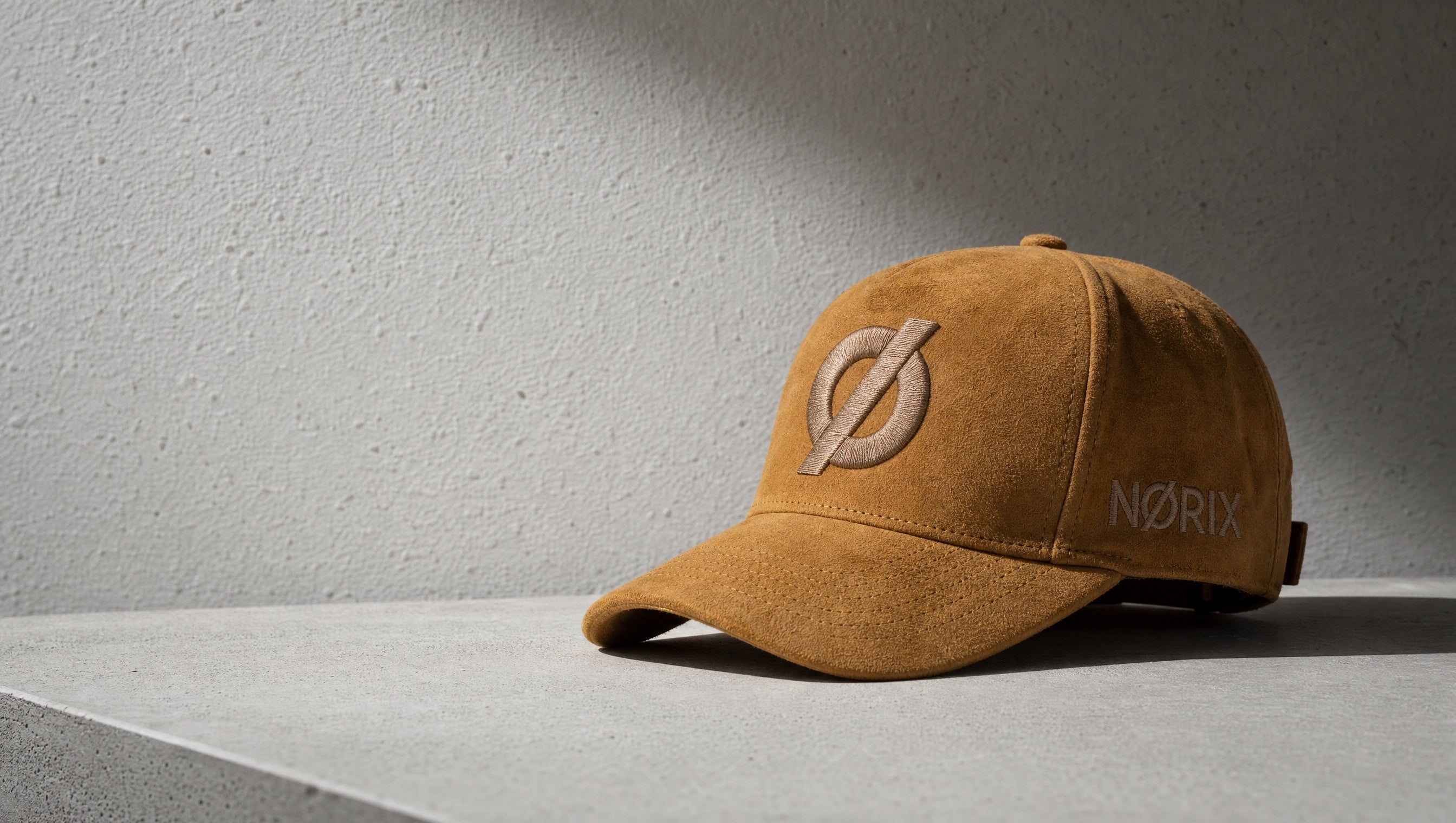 NØRIX mustard suede snapback in a minimal off-white editorial setting